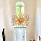 Sputnik d'Or Starburst Chandelier - illuminated evening dining room