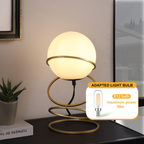 Aurea Spiral Glass Globe Bedside Lamp - on nightstand beside bed