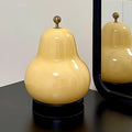 Poire portable touch lamp on a nightstand