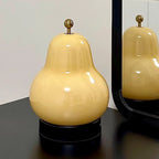 Poire portable touch lamp on a nightstand
