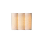 Vague sconce styled beside a headboard