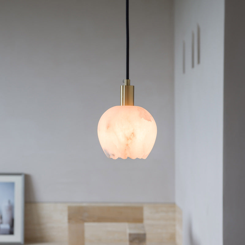 Petit Cuivré copper pendant lamp above a reading chair