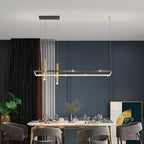 Infini black and gold infinity table lamp glowing on a desk