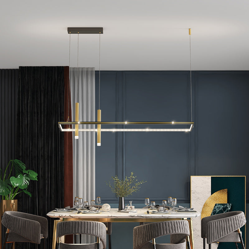 Infini black and gold infinity table lamp glowing on a desk