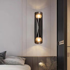 Solstice Marble-Finish Wall Sconce - illuminated warm glow at dusk