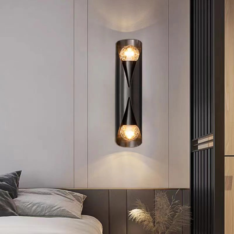 Solstice Marble-Finish Wall Sconce - illuminated warm glow at dusk