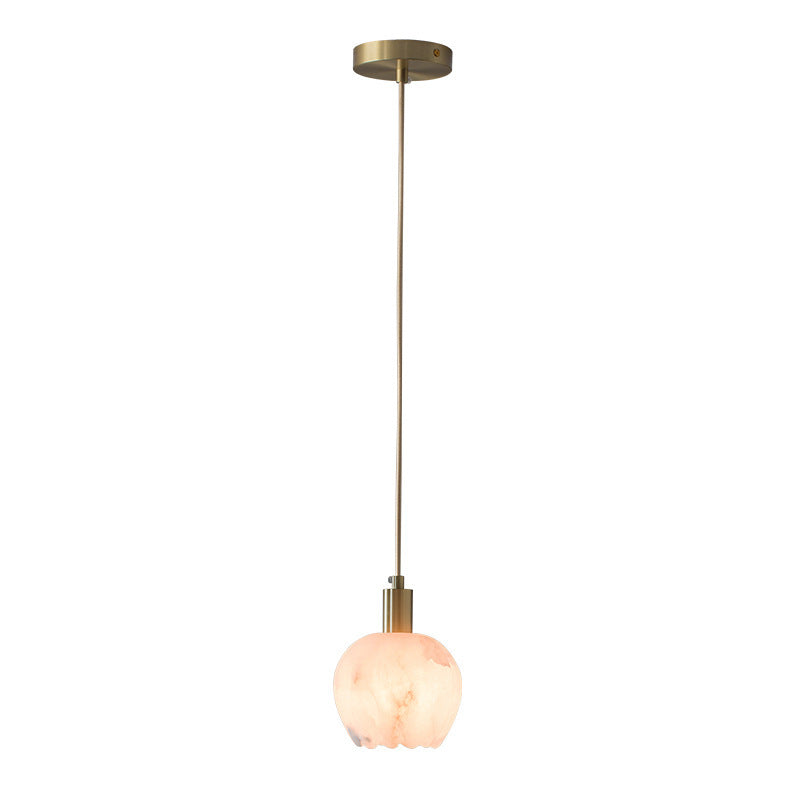 Petit Cuivré lamp styled above a bedside table