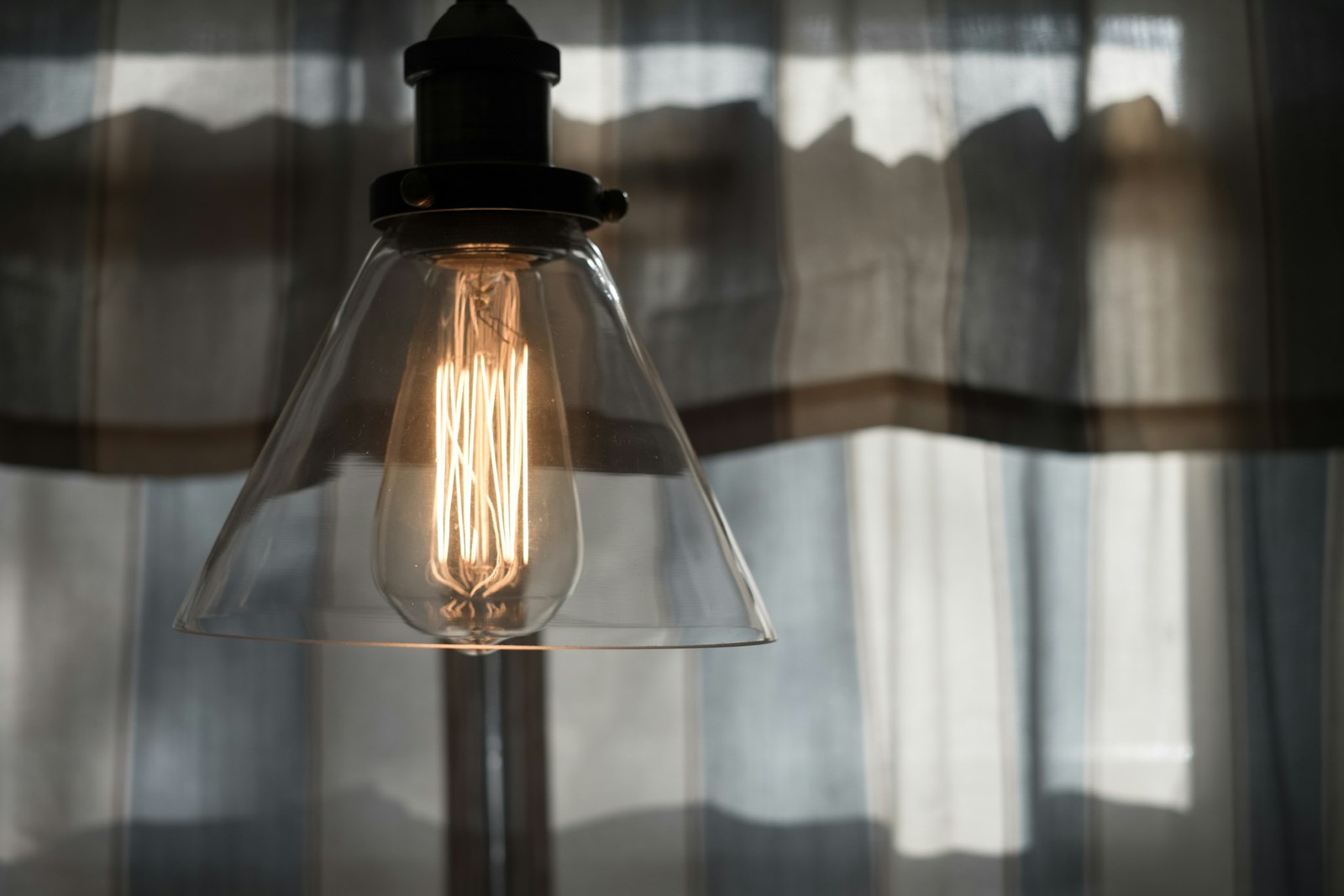 Facet Smoked Glass Pendant Cluster hanging above a dining table