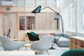 Tripod Studio Floor Lamp beside a living room sofa