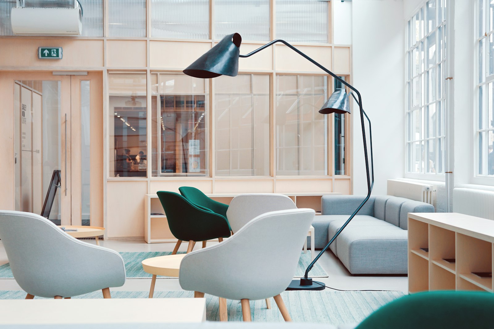 Tripod Studio Floor Lamp beside a living room sofa